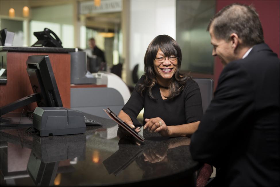 Banker helping customer with tablet