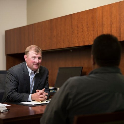 Banker at desk looking at customers