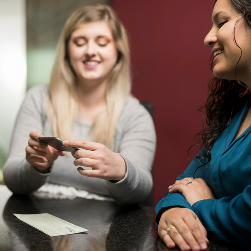 Two women smiling using Photo Deposit