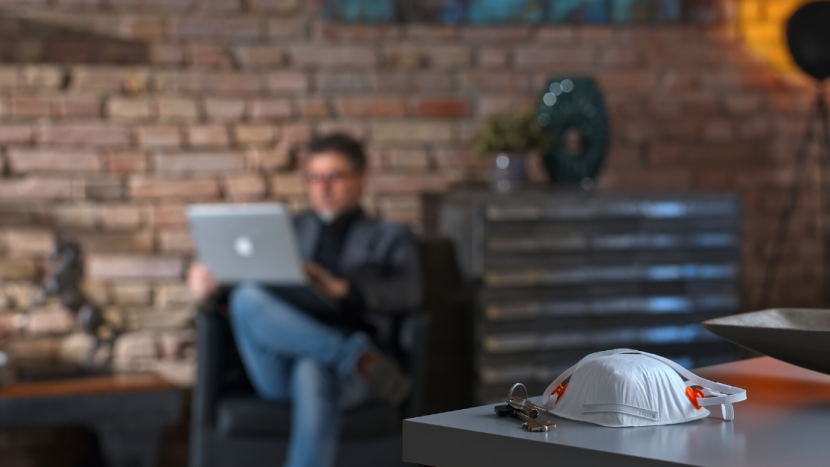 Mask with man blurred in background on laptop