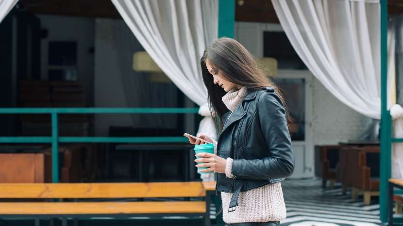 woman walking using cell phone