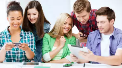 Teenagers using phones and tablets