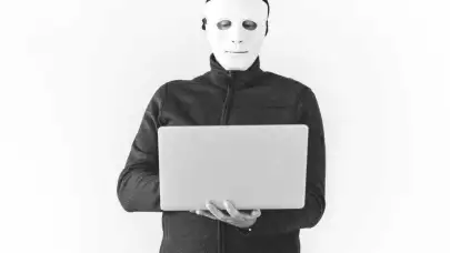 man in mask using laptop